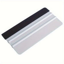 A precision scratch-free decal applicator tool with a black and white layered design.