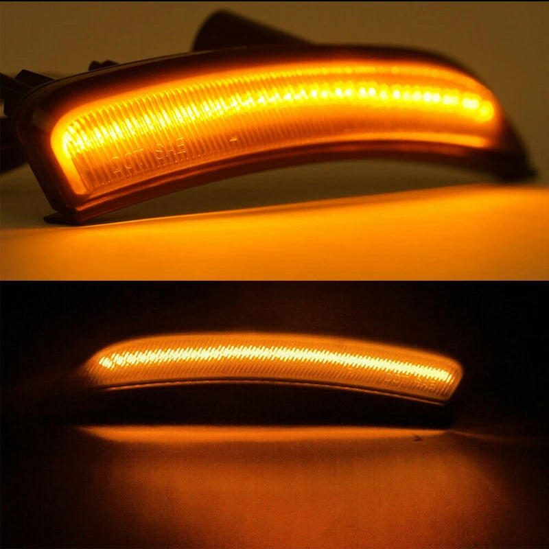 Vista cercana de luces direccionales LED ahumadas para un Chrysler 200, mostrando un brillo naranja.
