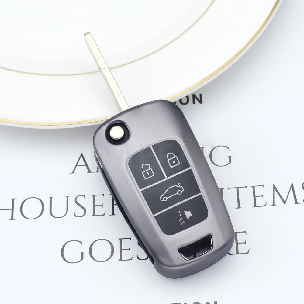 A close-up of a gray universal car key cover resting on a white circular background.