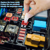 A hand is easily replacing automotive blade fuses in a vehicle electrical panel.