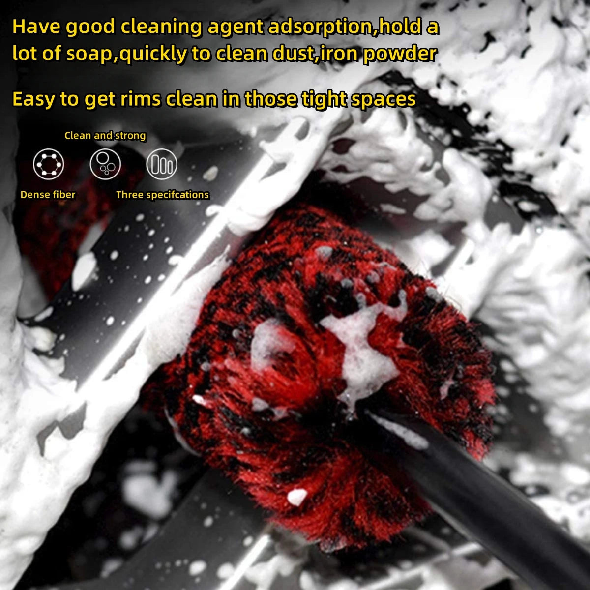 A close-up view of a red detailing brush cleaning dirt from tight spaces.