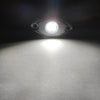 Close-up view of a bright LED underbody rock light illuminating a white surface.