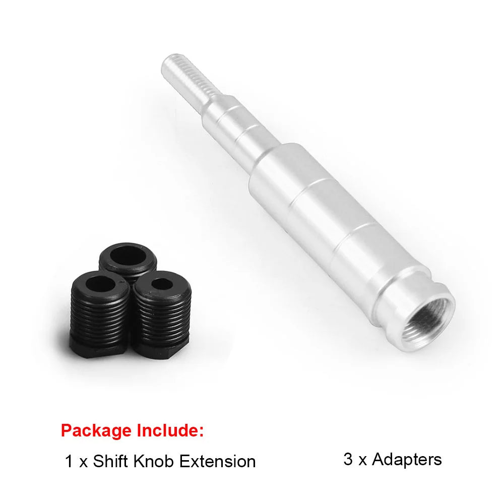 A silver aluminum gear knob extension and three black adapters for a shift lever.
