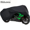 Black motorcycle cover with green accents protecting a sport bike.