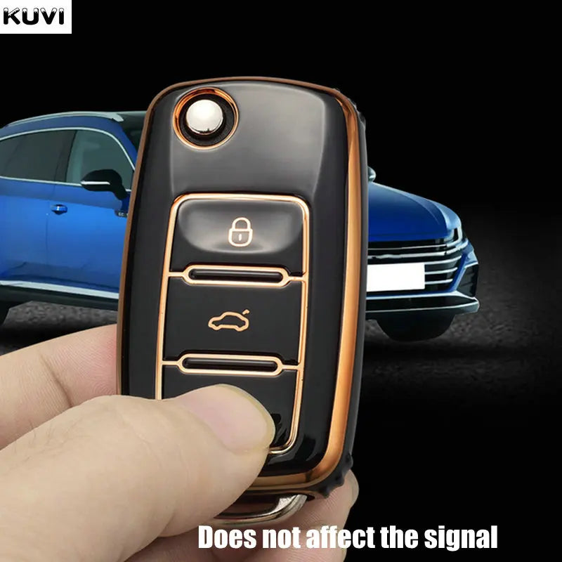 A hand holds a black TPU car key cover with an electronic component, demonstrating its design.