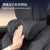 A hand is touching a black car headrest featuring memory foam and leather upholstery.