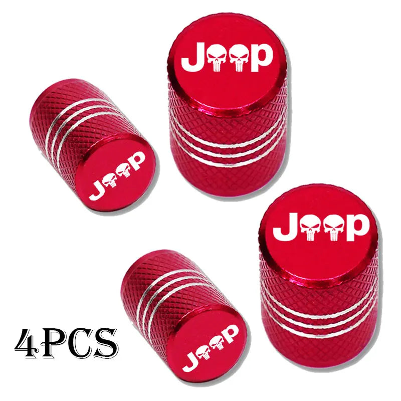 Four shiny red Jeep tire valve caps with silver stripes.