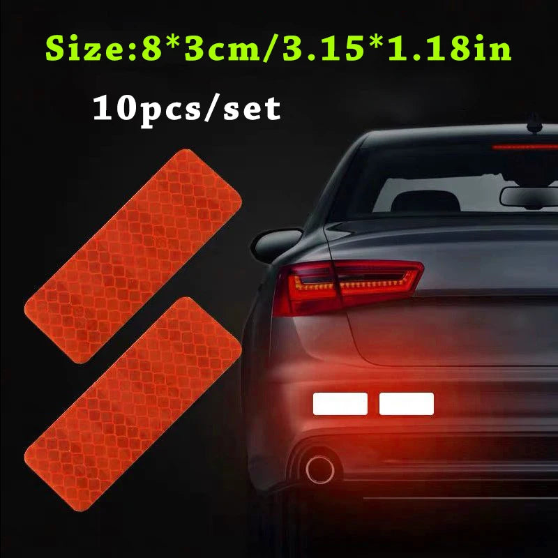 Ten pieces of orange reflective safety strips for vehicle use shown next to a car's taillight.