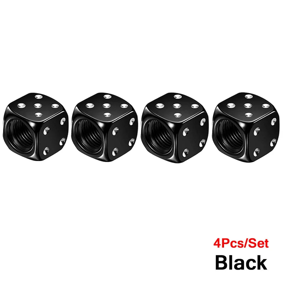 A set of four black aluminum dice valve caps for tires.