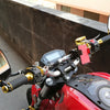A close-up of a red motorcycle featuring universal rearview mirrors mounted on the handlebars.