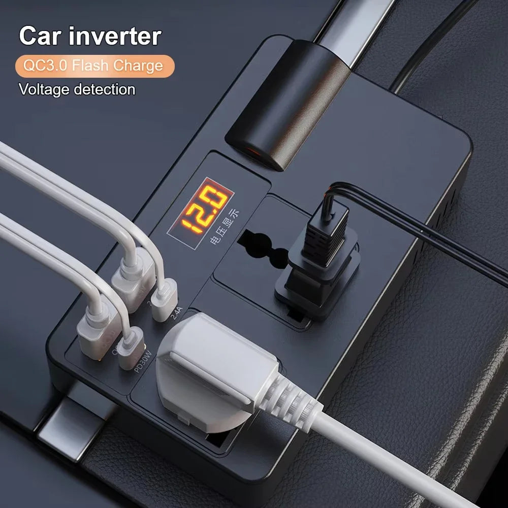 A black car inverter device with a digital display showing 120 volts and various cables and plugs.