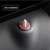 A close-up of a red diamond decorative car door lock pin set on a black leather surface.
