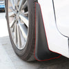 Close-up view of a car wheel with black mud flaps installed on the fender.