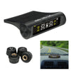 A black TPMS tire pressure monitoring system device and four corresponding sensors for automotive use.