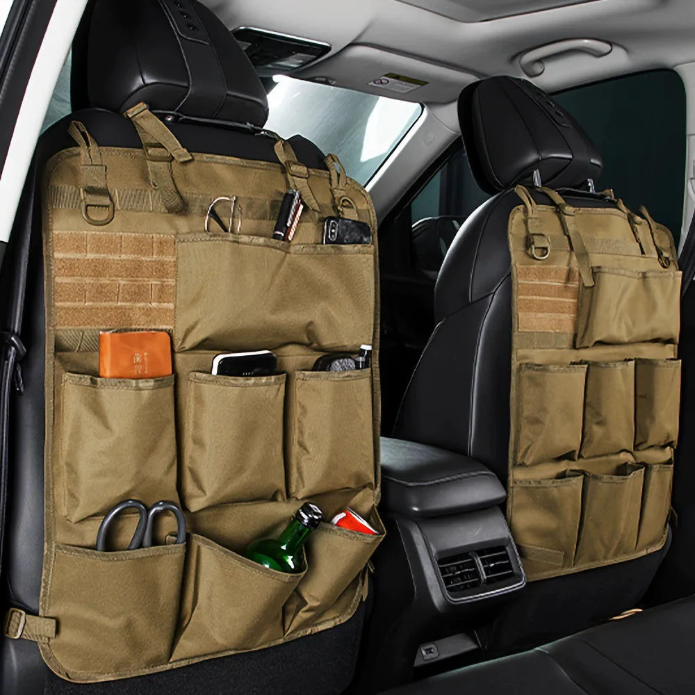 A tan canvas seat back organizer with multiple pockets and compartments installed in a car interior.