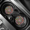 A close-up view of a black silicone coaster set with intricate mandala designs inside a device.