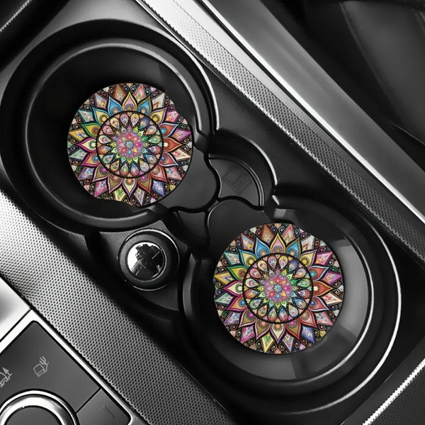 A close-up view of a black silicone coaster set with intricate mandala designs inside a device.