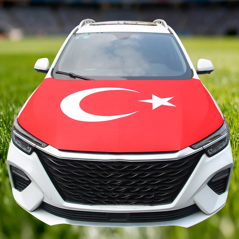 A white car hood decorated with a red flag featuring the Turkish crescent and star.