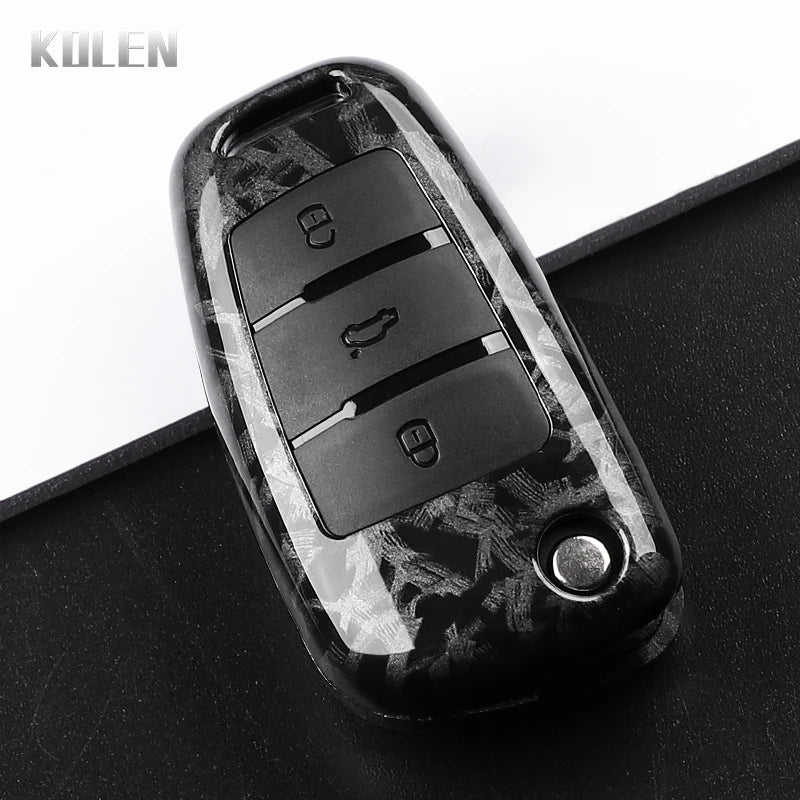 A black carbon fiber car key case cover with multiple buttons and a round key slot.