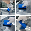 A hand is using a blue and black vinyl tint film installation tool kit to apply film to a car window.