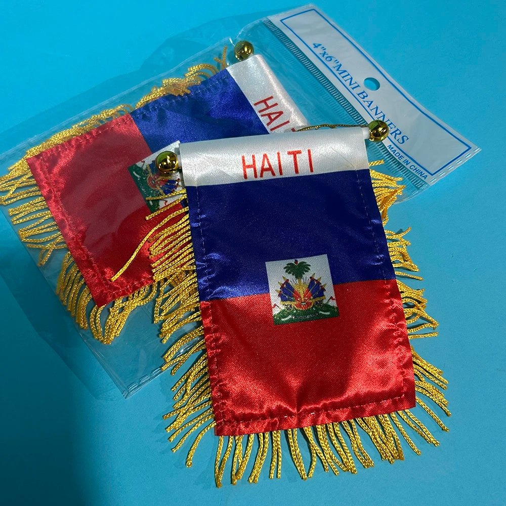 A red, white, and blue Haiti flag banner with gold fringe is displayed in clear plastic packaging.