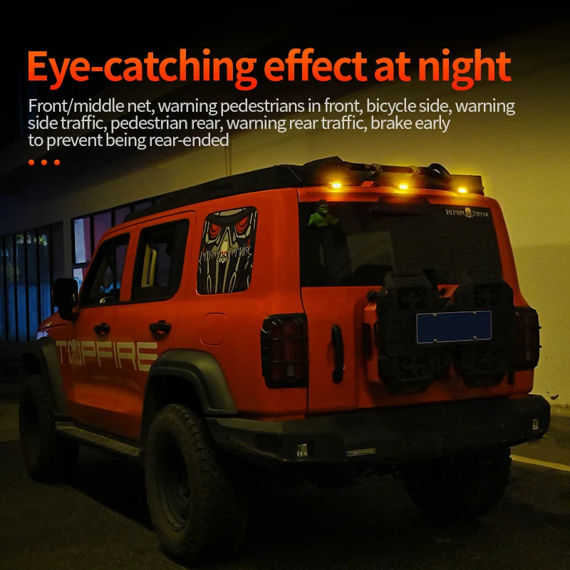 Orange Jeep truck equipped with eye-catching front and rear lights for nighttime visibility.