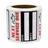 A roll of oil change reminder stickers with black and white stripes and text indicating next service due date and miles.