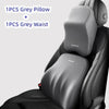 A grey pillow and waist support are shown placed on a black car headrest cushion.