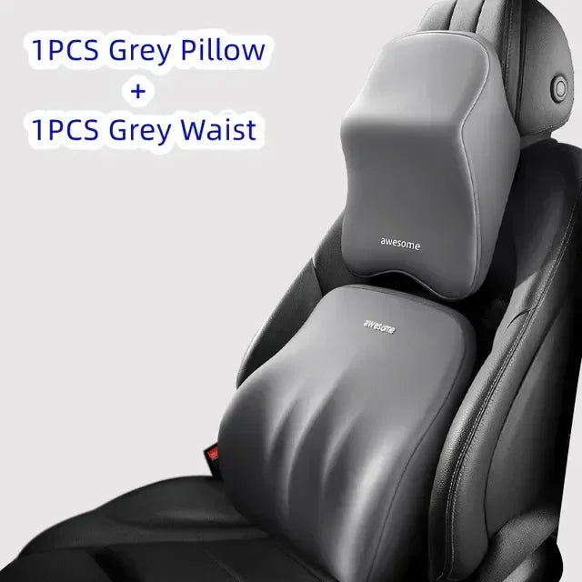 A grey pillow and waist support are shown placed on a black car headrest cushion.