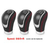 Three black manual gear shift knobs with interchangeable speed covers labeled 5/6/5+R