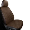 A close-up view of a brown quilted car seat and floor mat.