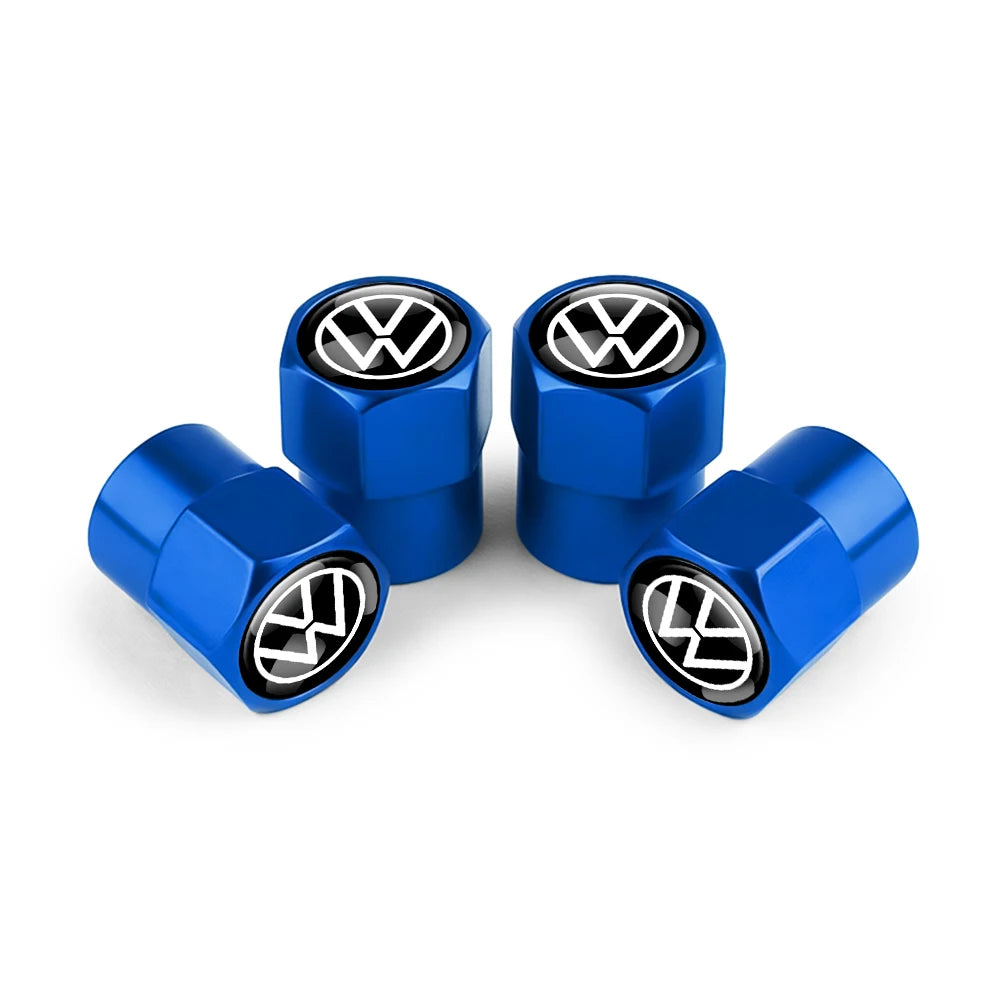 Three blue metal tire valve caps with VW logos displayed on a white background.