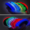 A hand holds a set of colorful LED car cup holder coasters, displaying various vibrant colors like blue, green, red, and purp