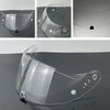 Clear motorcycle helmet visor lens with multiple mounting points and a flexible design.