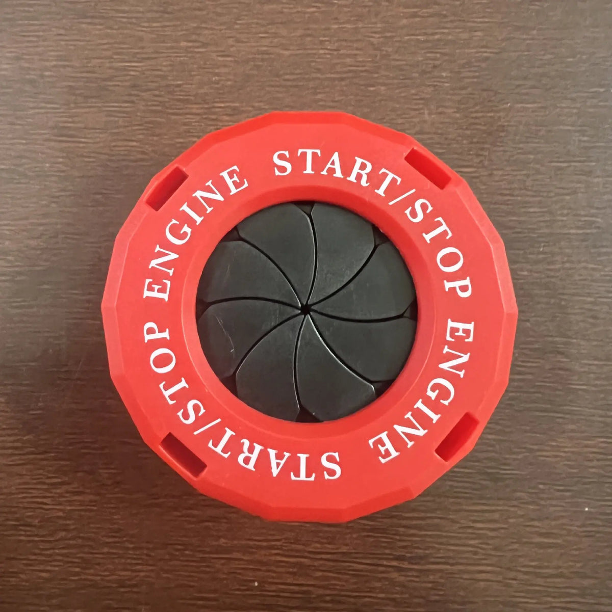 Red decorative ignition cover with a black center, labeled START/STOP ENGINE.