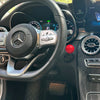 Interior view of a car dashboard showing the steering wheel and controls.