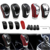 A variety of black and red manual gear shift knobs with interchangeable speed covers shown in different angles.
