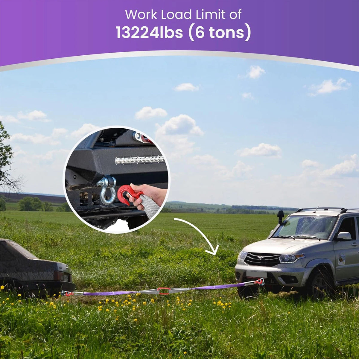 Heavy duty lifting slings with hooks shown stretched across a grassy field near a pickup truck.