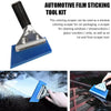 A silver and blue automotive film sticking tool kit is shown being used to clean a car window.