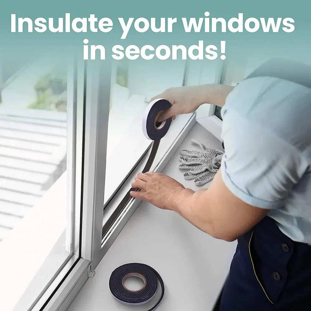 A person is applying black foam sealing tape to the frame of a window to insulate it.