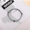 A white heart-shaped fitness tracker bracelet is displayed on a white background with a black label.