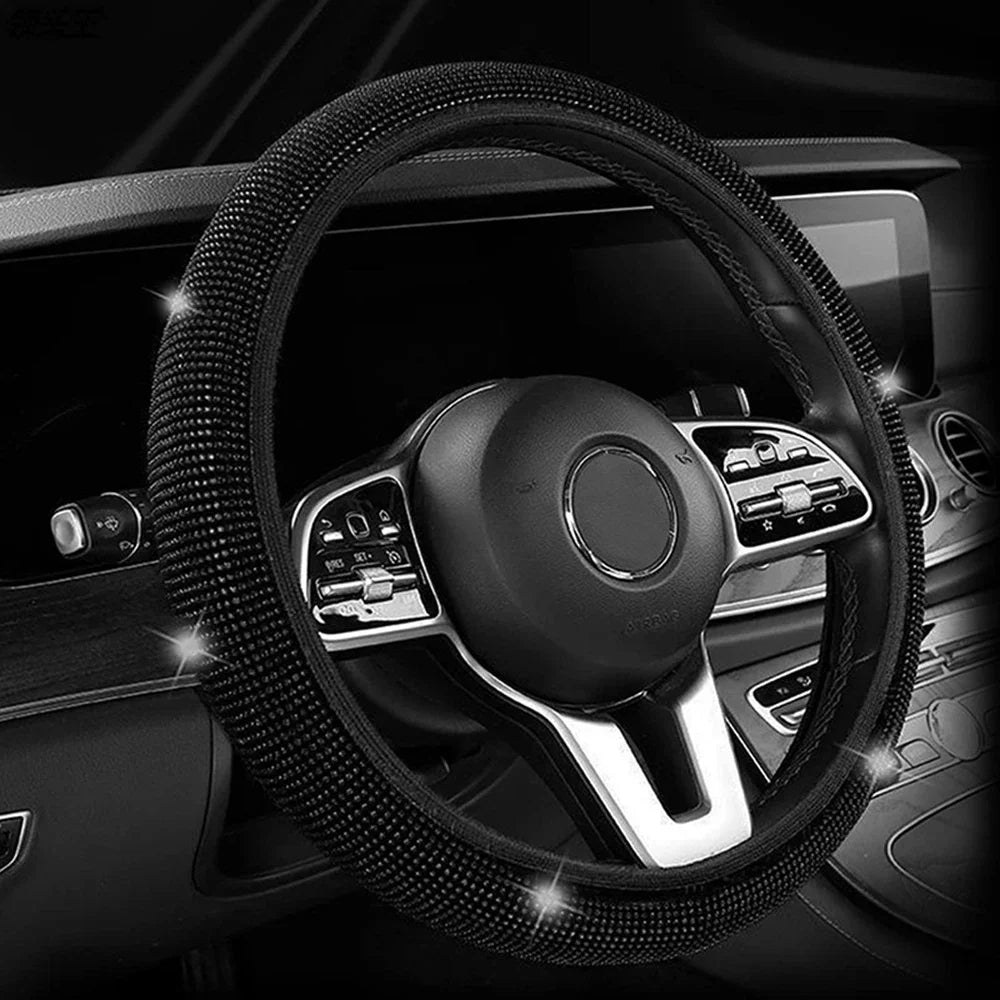 Black crystal diamond rhinestone steering wheel cover installed in a car interior.