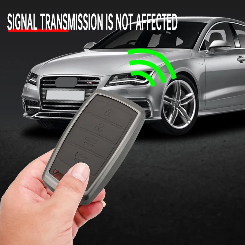 A hand holds a gray zinc alloy car key case near a silver Hyundai Genesis vehicle, demonstrating signal transmission is not a