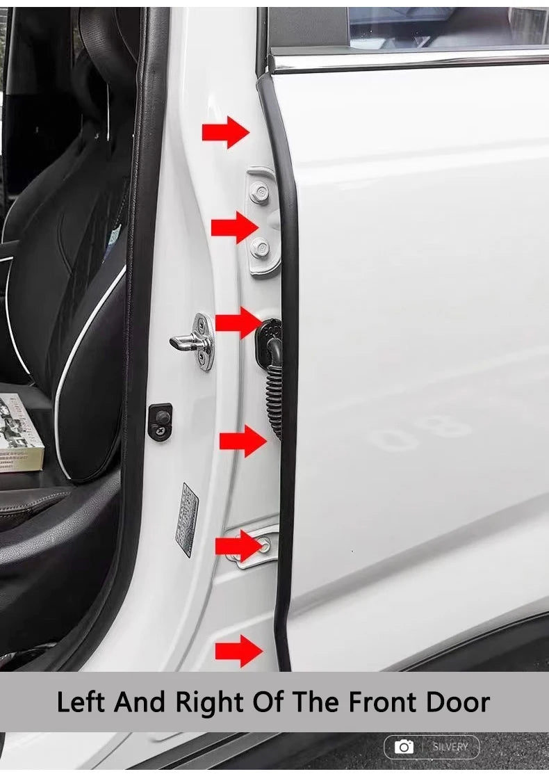 Close-up view of a white car door showing various weatherstrip seal strips and door components.