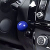 Close-up of a blue push start ignition button cover on a black car interior panel.