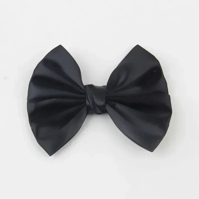 A black silk hair bow tied in a classic bow shape.
