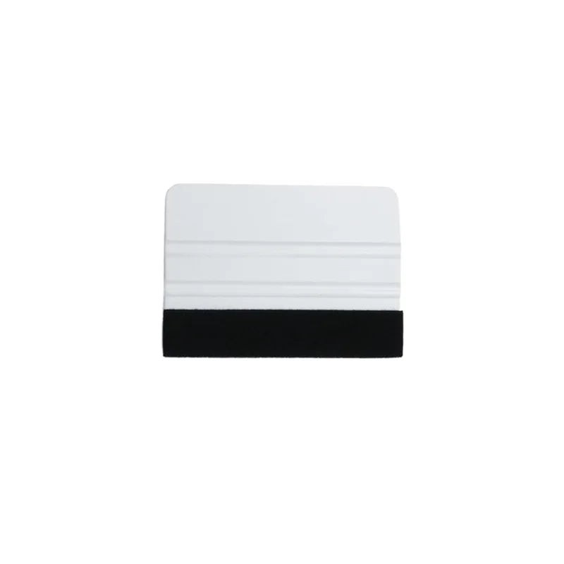 A rectangular felt squeegee tool with a white top section and a black bottom section.
