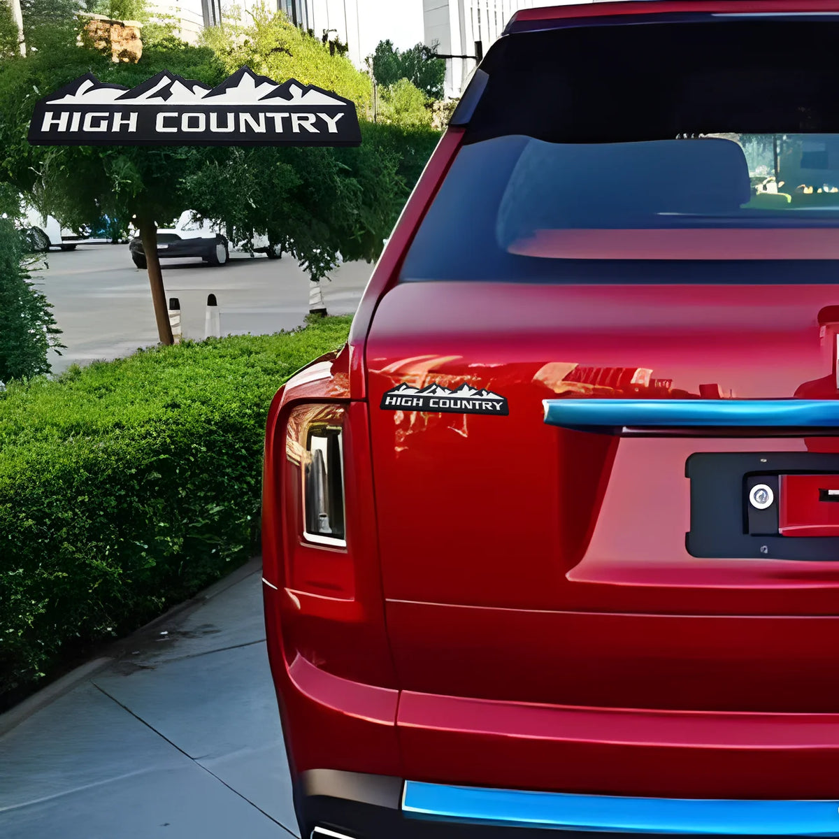 Rear view of a red truck with a High Country decal and blue trim.