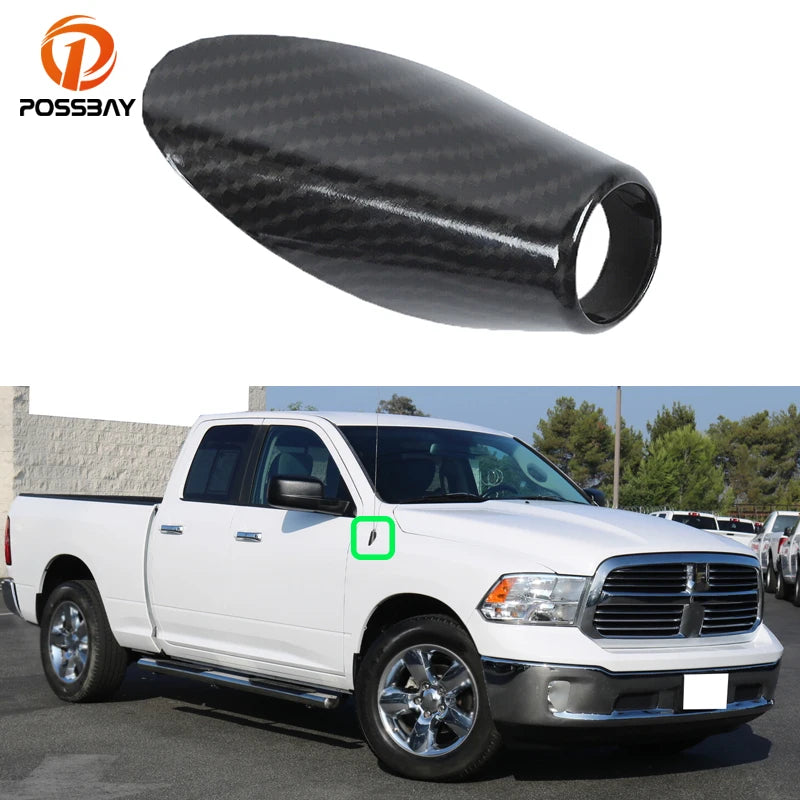 A white Dodge RAM pickup truck with a carbon fiber look antenna base trim installed.