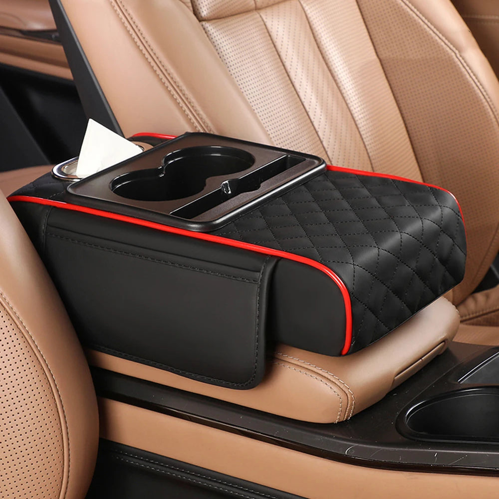 A black multifunctional car armrest cushion with a tissue holder is placed on a tan leather car seat.